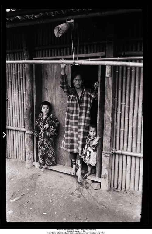 Woman and two children at front entrance