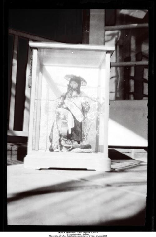 Japanese doll in glass case