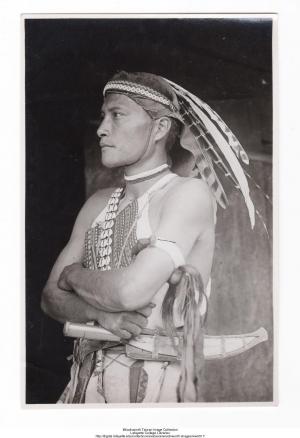 Man in Leather and Feather Headdress with Large Knife